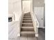 Staircase with wood steps and white railing leading to the upper level at 6250 W Flamingo Rd # 103, Las Vegas, NV 89103