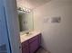 Close up of the downstairs bathroom, with pink vanity, large mirror, and beige floors at 6250 W Flamingo Rd # 157, Las Vegas, NV 89103