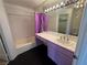 Bathroom featuring a tub, sink, and purple shower curtain at 6250 W Flamingo Rd # 157, Las Vegas, NV 89103