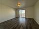Bedroom with wood floors and sliding glass doors leading to a balcony at 6250 W Flamingo Rd # 157, Las Vegas, NV 89103