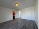 Spacious bedroom with hardwood floors, a light fixture, and an ensuite bathroom at 6250 W Flamingo Rd # 157, Las Vegas, NV 89103