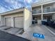 Beige townhouse with attached garages, driveways with parking spaces, and second story balconies at 6250 W Flamingo Rd # 157, Las Vegas, NV 89103