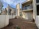 An exterior view showing a two-story condo with balcony access and a low-maintenance gravel yard at 6250 W Flamingo Rd # 157, Las Vegas, NV 89103