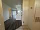 Hallway with wood-look floors leading to the living room and stairs going to the second floor at 6250 W Flamingo Rd # 157, Las Vegas, NV 89103