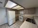 Kitchen with white appliances, tile countertops, and white tile flooring at 6250 W Flamingo Rd # 157, Las Vegas, NV 89103