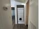 Hallway with laundry closet featuring stacked washer and dryer unit at 6250 W Flamingo Rd # 157, Las Vegas, NV 89103