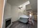 Living room featuring wood-look flooring, fireplace, ceiling fan and stairs to the second floor at 6250 W Flamingo Rd # 157, Las Vegas, NV 89103