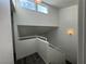 Bright staircase with white railing, gray wood-look floors and windows allowing natural light to flood the space at 6250 W Flamingo Rd # 157, Las Vegas, NV 89103