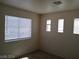 This bedroom features three windows with blinds, neutral walls, and carpet at 70 Belle Essence Ave, Las Vegas, NV 89123