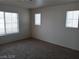 This bedroom features neutral walls, carpet, and ample natural light from three windows at 70 Belle Essence Ave, Las Vegas, NV 89123