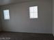 Neutral walls, carpet, and two windows featured in this bedroom at 70 Belle Essence Ave, Las Vegas, NV 89123