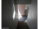 Entryway with stairs leading up to a light pink door and light wood floors at 70 Belle Essence Ave, Las Vegas, NV 89123