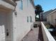 Beige stucco home with a white door, rock landscaping and an air conditioning unit at 70 Belle Essence Ave, Las Vegas, NV 89123