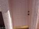 Close up of a light pink front door with gold hardware and stucco walls at 70 Belle Essence Ave, Las Vegas, NV 89123