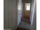Hallway with multiple white doors and carpet leading to a room with a window at 70 Belle Essence Ave, Las Vegas, NV 89123