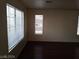Bright, open living room featuring dark wood floors and ample natural light at 70 Belle Essence Ave, Las Vegas, NV 89123