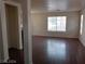 Spacious living room featuring hardwood floors, bright windows, and an open layout at 70 Belle Essence Ave, Las Vegas, NV 89123