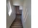 A staircase leading to a basement with carpeted steps and natural lighting at 70 Belle Essence Ave, Las Vegas, NV 89123