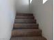 Carpeted stairs leading up to the second floor with white walls at 70 Belle Essence Ave, Las Vegas, NV 89123