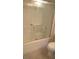 Bright bathroom featuring a glass-doored shower and toilet at 7290 Sheared Cliff Ln # 102, Las Vegas, NV 89149