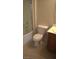 View of the bathroom featuring a toilet, sink and a bathtub with clear glass doors at 7290 Sheared Cliff Ln # 102, Las Vegas, NV 89149