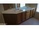 Bright bathroom featuring dual sinks, vanity and a window for natural light at 7290 Sheared Cliff Ln # 102, Las Vegas, NV 89149