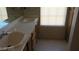 Dual sink bathroom vanity with a window that provides natural light at 7290 Sheared Cliff Ln # 102, Las Vegas, NV 89149