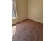 Neutral carpeted bedroom with a window letting in natural light and plain white walls at 7290 Sheared Cliff Ln # 102, Las Vegas, NV 89149