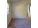 Neutral carpeted bedroom with a window letting in natural light and plain white walls at 7290 Sheared Cliff Ln # 102, Las Vegas, NV 89149