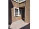 Exterior of home with a window and doorway, surrounded by brick pavers at 7290 Sheared Cliff Ln # 102, Las Vegas, NV 89149