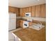 Well-lit kitchen features wood cabinets, granite countertops, and modern appliances at 7290 Sheared Cliff Ln # 102, Las Vegas, NV 89149