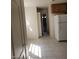 The kitchen has tile flooring, white appliances, and wood cabinets at 7290 Sheared Cliff Ln # 102, Las Vegas, NV 89149