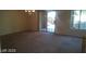 Bright living room features plush carpet, abundant natural light, and convenient staircase access at 7290 Sheared Cliff Ln # 102, Las Vegas, NV 89149