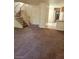 Cozy living area with staircase, tiled entry and a pass-through to the adjacent kitchen at 7290 Sheared Cliff Ln # 102, Las Vegas, NV 89149