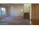 Bright living room features plush carpet, abundant natural light, and convenient staircase access at 7290 Sheared Cliff Ln # 102, Las Vegas, NV 89149