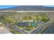 Expansive aerial view of community with a golf course, tennis courts and lush green spaces at 7745 Fruit Dove St, North Las Vegas, NV 89084