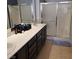 Bathroom featuring a double sink vanity and a sliding glass door shower at 7745 Fruit Dove St, North Las Vegas, NV 89084