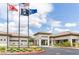 Welcoming Sun City Aliante building with flags, manicured landscaping, and accessible entrance at 7745 Fruit Dove St, North Las Vegas, NV 89084