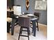 Cozy dining area with sleek black table and bar-style chairs at 7745 Fruit Dove St, North Las Vegas, NV 89084