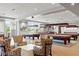Spacious game room featuring multiple billiard tables, stylish seating, and abundant natural light at 7745 Fruit Dove St, North Las Vegas, NV 89084