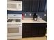 Kitchen appliances including a range, microwave, and white cabinets at 7745 Fruit Dove St, North Las Vegas, NV 89084