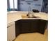 Kitchen sink and counter with black cabinets and tile floor at 7745 Fruit Dove St, North Las Vegas, NV 89084