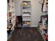 Spacious walk-in closet with shelves for storage and a grey rug on the floor at 7745 Fruit Dove St, North Las Vegas, NV 89084