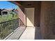 Balcony area with beige door and view of community foliage at 8324 W Charleston Blvd # 2033, Las Vegas, NV 89117