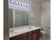 Bathroom featuring a double sink vanity, a large mirror and a tiled shower/tub combo at 8324 W Charleston Blvd # 2033, Las Vegas, NV 89117