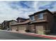 Attractive condo community with attached garages, brown stucco, and tiled roofs at 8324 W Charleston Blvd # 2033, Las Vegas, NV 89117