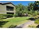 A two-story home with landscaped lawn and mature trees, providing a serene outdoor setting at 8324 W Charleston Blvd # 2033, Las Vegas, NV 89117