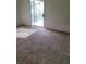 Bright living room features neutral carpet and sliding glass doors to the outside at 8324 W Charleston Blvd # 2033, Las Vegas, NV 89117