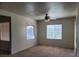 Open living room featuring a ceiling fan, multiple windows, and carpeted flooring at 8324 W Charleston Blvd # 2033, Las Vegas, NV 89117