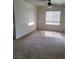 Bright living room with a ceiling fan and two windows that provide plenty of natural light at 8324 W Charleston Blvd # 2033, Las Vegas, NV 89117